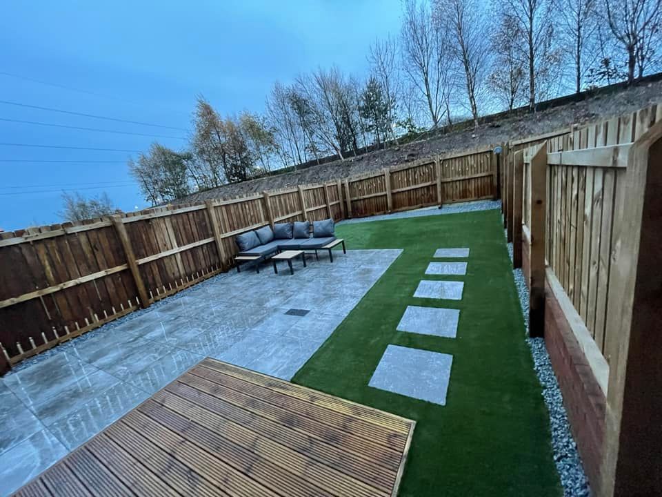 Another patio installed with outdoor porcelain and artificial grass.