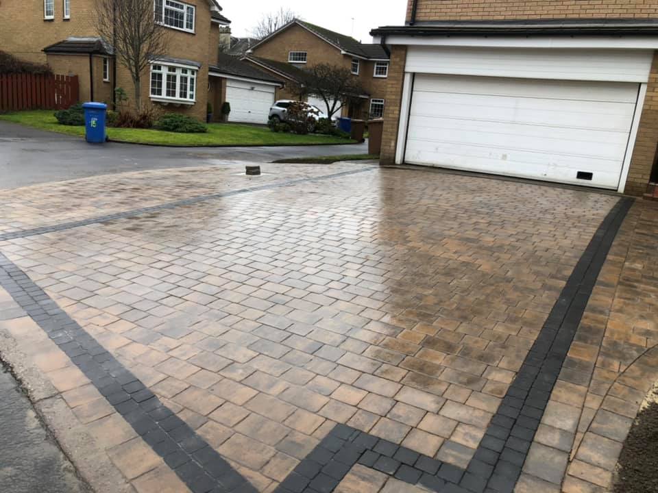 Laird cobble driveway installed with charcoal sett border.