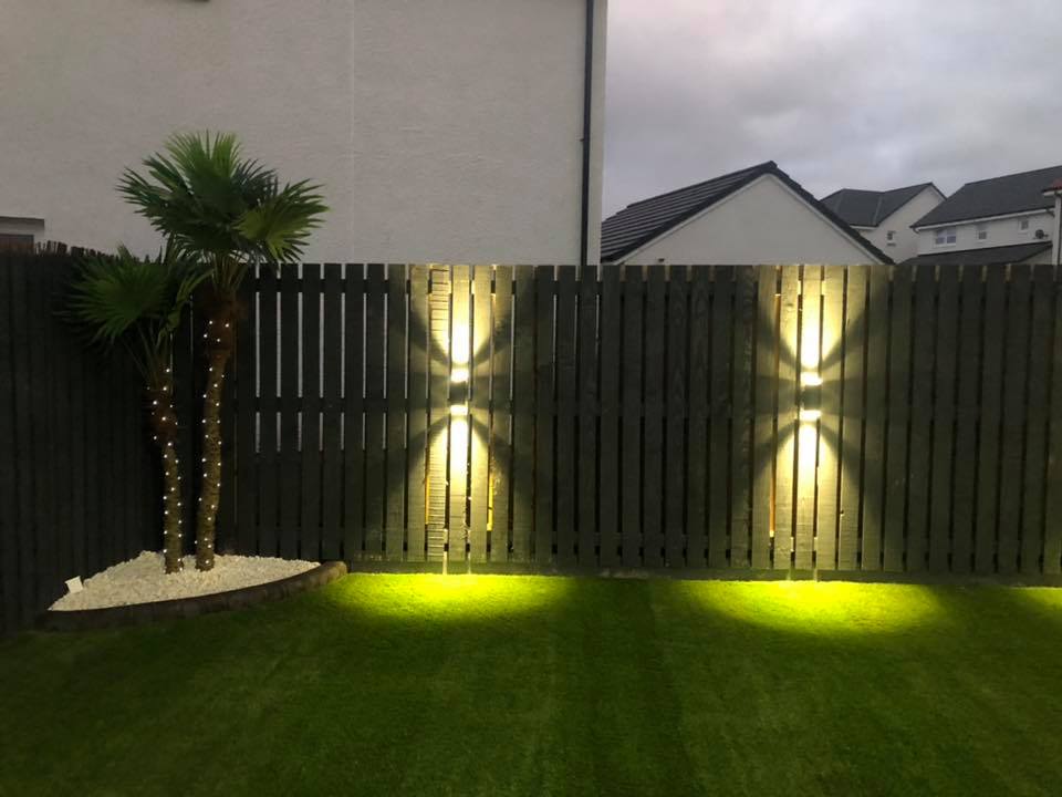 Garden fence with lights, artificial turf and artificial trees