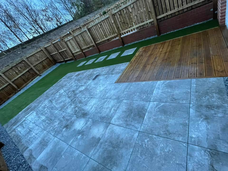 Another patio installed with outdoor porcelain and artificial grass.