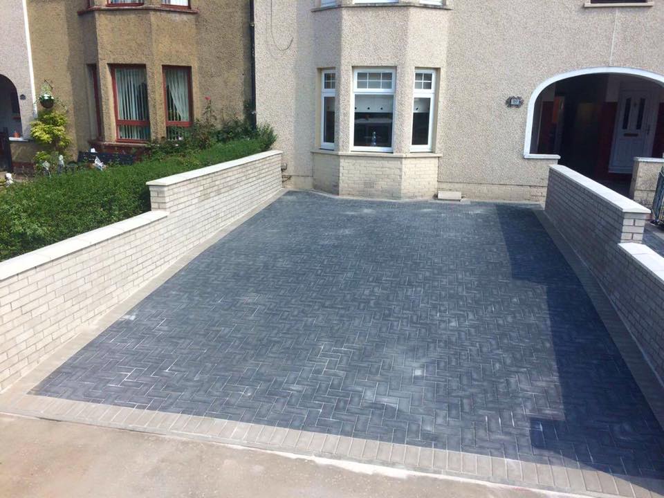 Before and after charcoal and light grey driveway with matching walls and pathway.