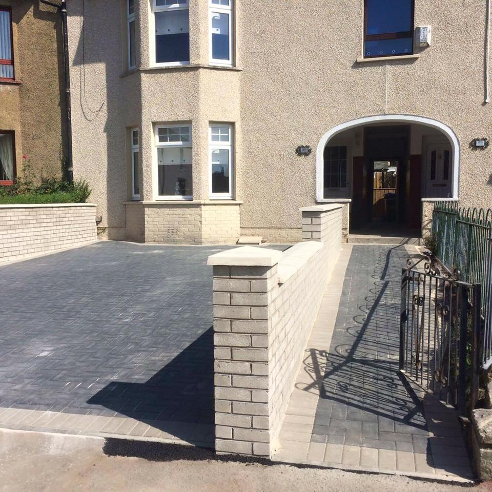 Before and after charcoal and light grey driveway with matching walls and pathway.
