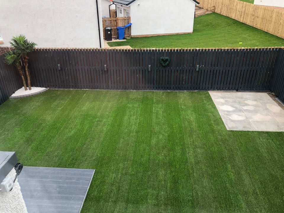 Finally getting some progress on my own garden while staying at home with my family. Artificial palm tree installed, 40mm striped artificial grass, decking extended, fence lights installed, base for playhouse, more to be added.
